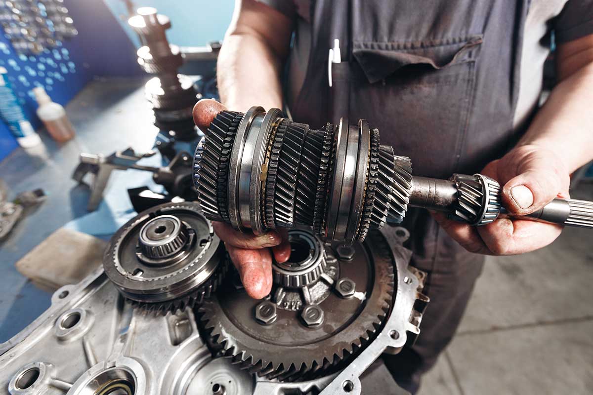 mechanic holding gearbox